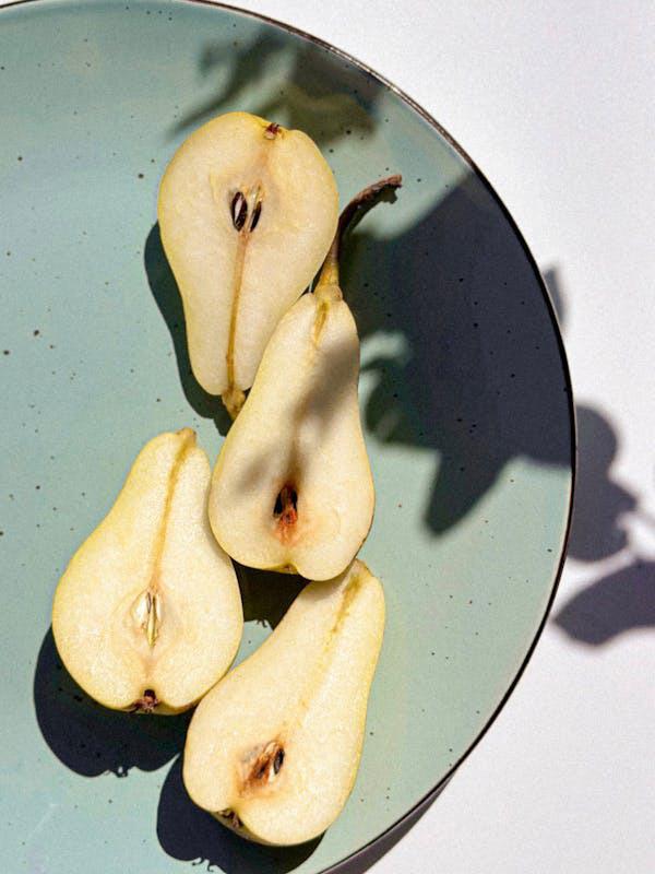 free-photo-of-shadow-cast-on-pear-halves-lying-on-ceramic-plate.jpeg